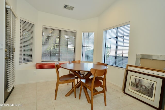 dining area featuring light tile patterned flooring, visible vents, and baseboards