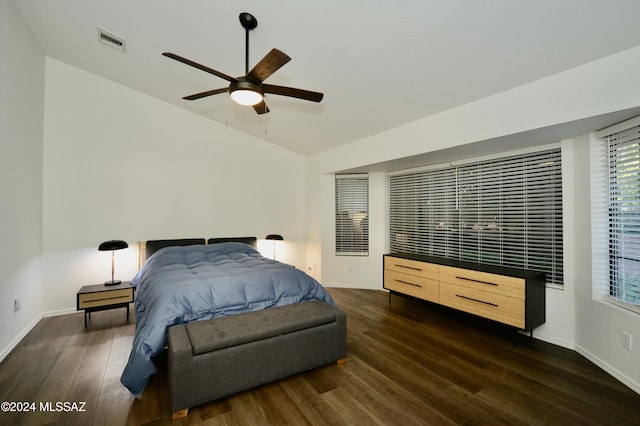 bedroom featuring vaulted ceiling, visible vents, dark wood finished floors, and baseboards