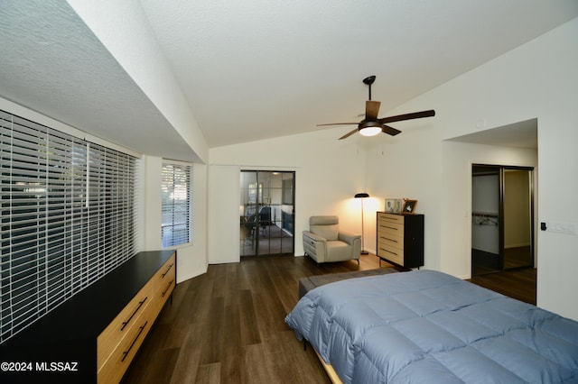 bedroom featuring dark wood-style floors, vaulted ceiling, a textured ceiling, and a ceiling fan