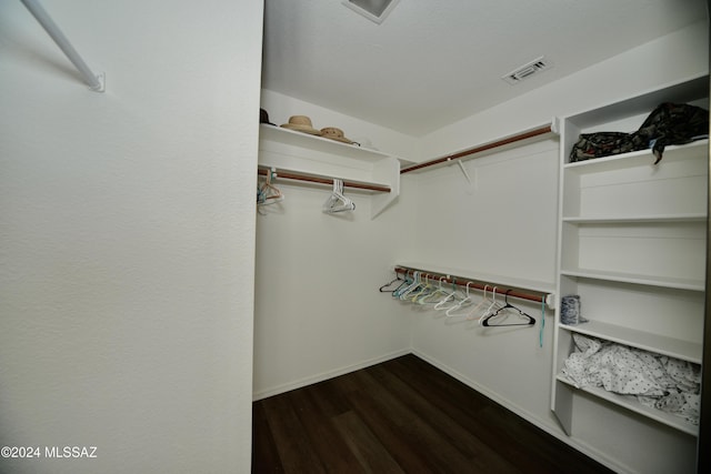 walk in closet with dark wood-style flooring and visible vents