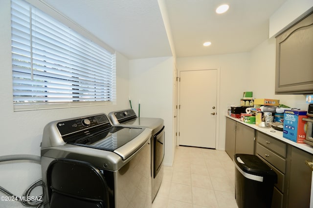 laundry area with light tile patterned floors, washing machine and dryer, cabinet space, and recessed lighting