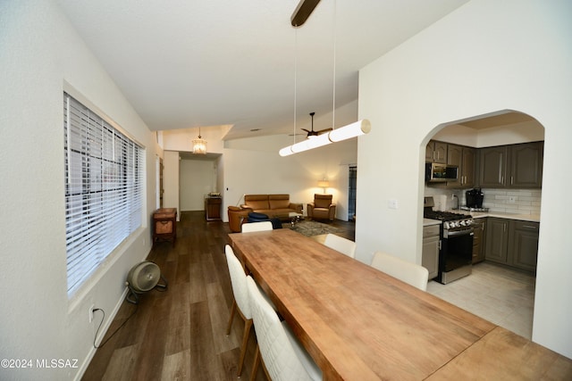 unfurnished dining area with ceiling fan, light hardwood / wood-style floors, and vaulted ceiling