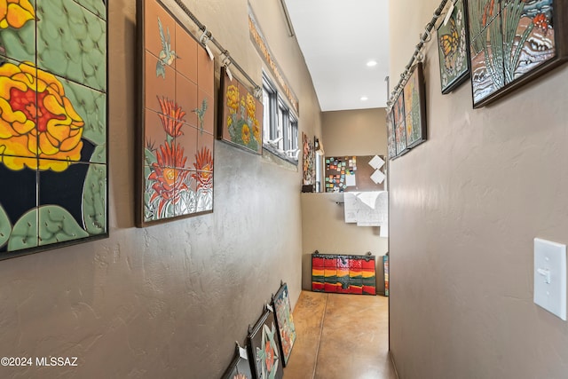 hall with concrete flooring and a barn door