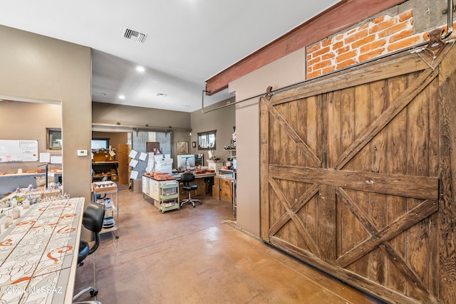 interior space with a barn door and concrete floors