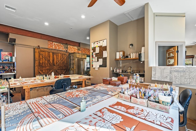 interior space with ceiling fan and a barn door