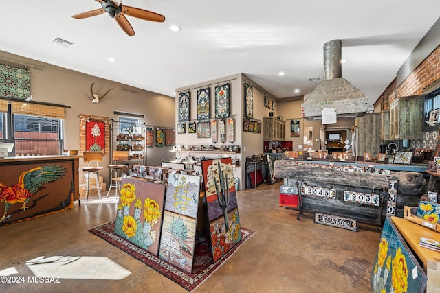 interior space featuring ceiling fan and concrete flooring