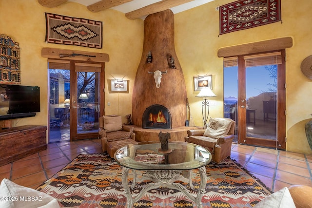 living room with a fireplace, a high ceiling, tile patterned flooring, beam ceiling, and french doors