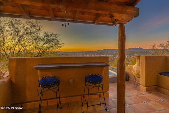 patio terrace at dusk with a mountain view