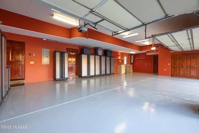 garage featuring a garage door opener and electric panel