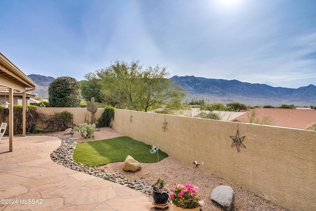 view of yard featuring a mountain view and a patio