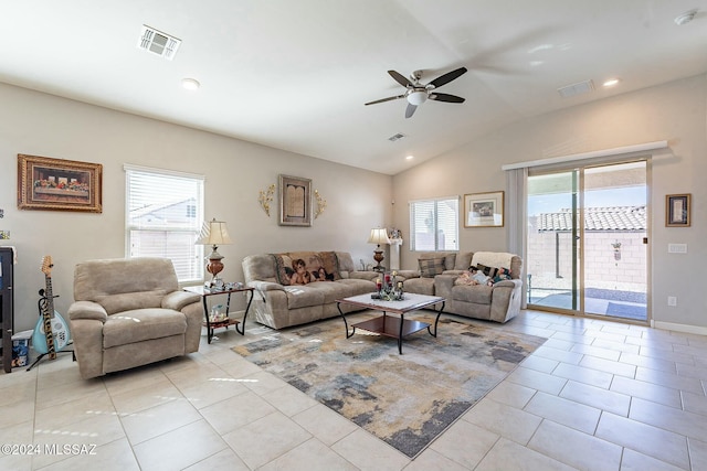 living room with plenty of natural light, ceiling fan, light tile patterned floors, and vaulted ceiling