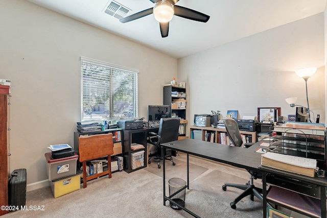 home office with ceiling fan and light carpet