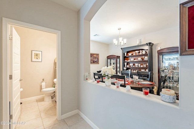 interior space featuring decorative light fixtures, an inviting chandelier, and light tile patterned flooring