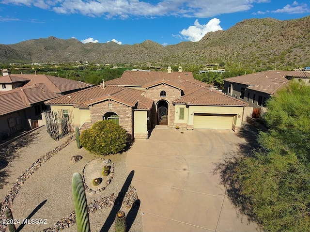 mediterranean / spanish house with a mountain view and a garage