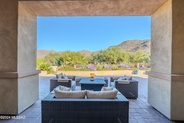 view of patio / terrace featuring an outdoor living space and a mountain view