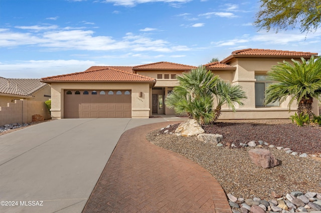 mediterranean / spanish-style home featuring a garage