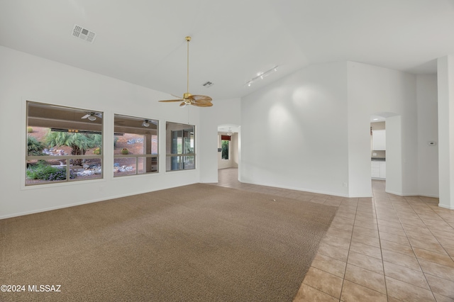 unfurnished living room featuring track lighting, ceiling fan, lofted ceiling, and light tile patterned flooring