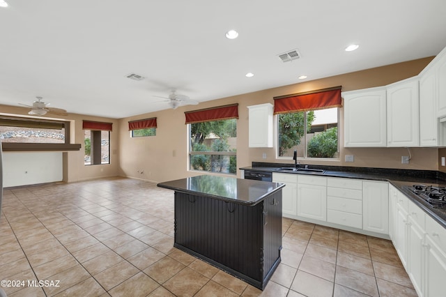 kitchen with ceiling fan, sink, white cabinets, and light tile patterned floors