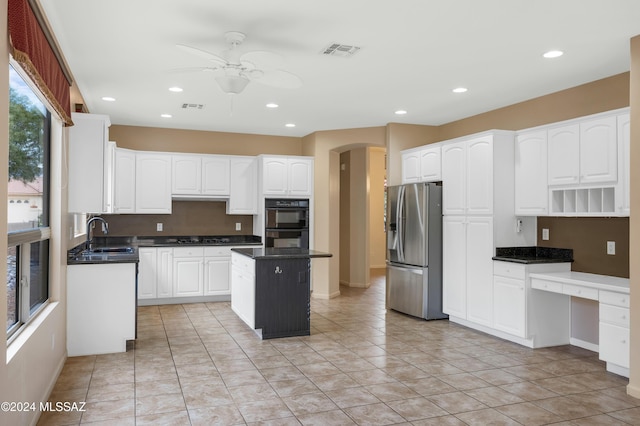 kitchen featuring a center island, white cabinets, sink, stainless steel refrigerator with ice dispenser, and ceiling fan