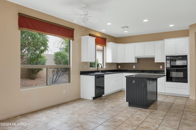 kitchen with a kitchen island, ceiling fan, black appliances, light tile patterned floors, and white cabinetry