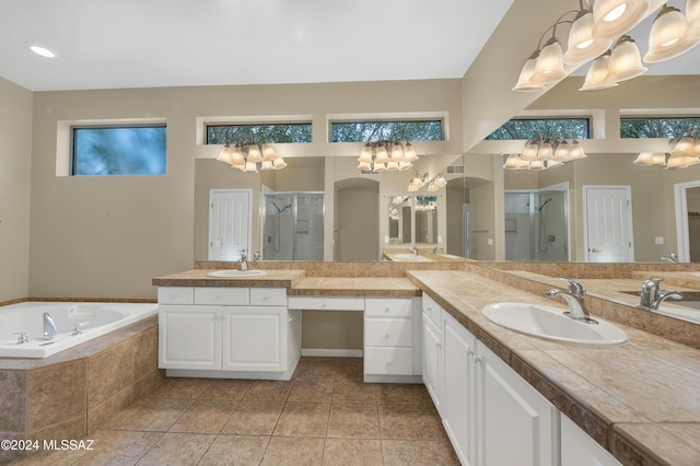 bathroom with tile patterned floors, vanity, and plus walk in shower