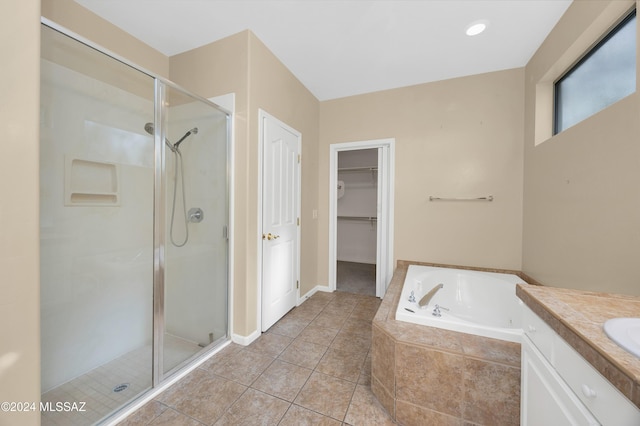 bathroom with tile patterned flooring, vanity, and independent shower and bath