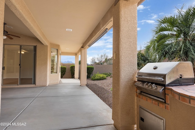 view of patio with area for grilling, grilling area, and ceiling fan