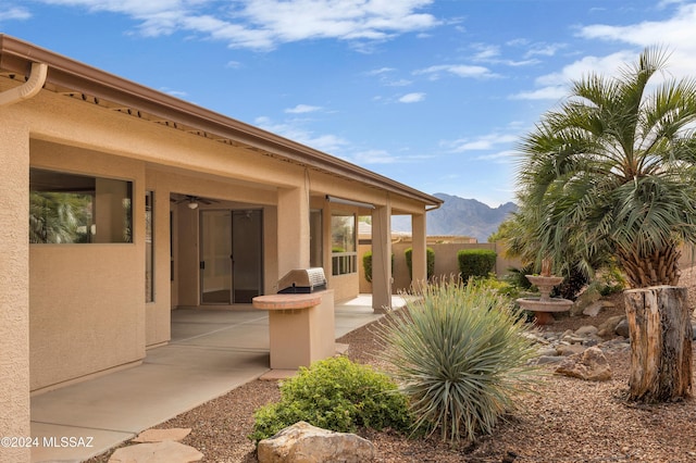 exterior space with a mountain view and a patio