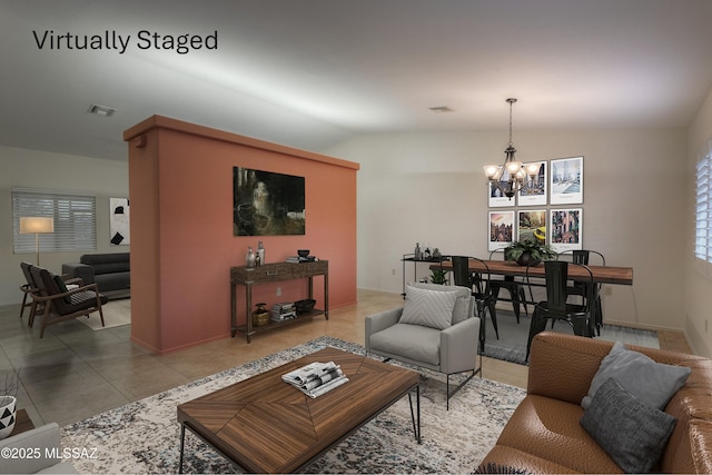 tiled living room with vaulted ceiling and a notable chandelier