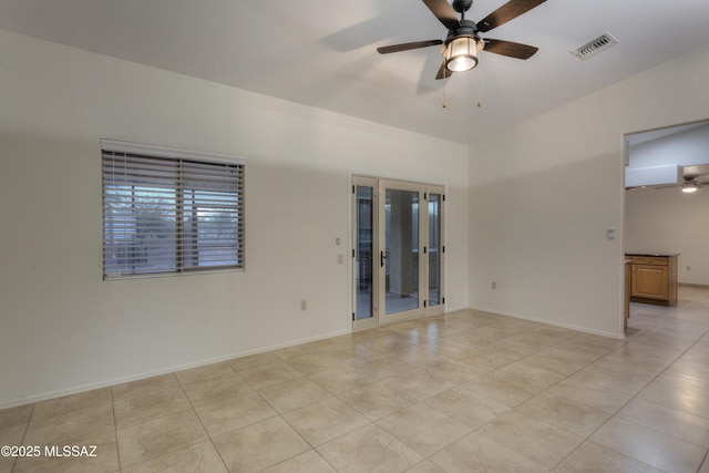 spare room featuring light tile patterned floors and ceiling fan