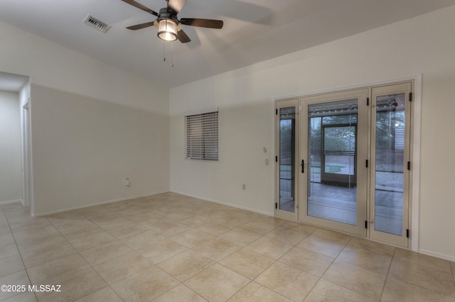 tiled empty room with ceiling fan