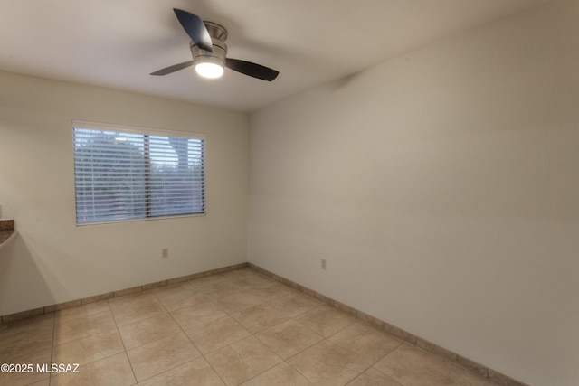 empty room featuring ceiling fan and light tile patterned floors