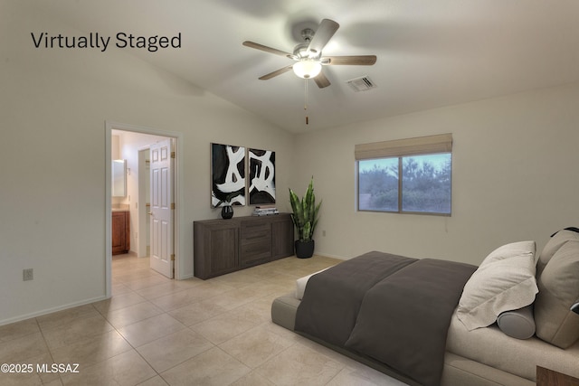 tiled bedroom with lofted ceiling, ceiling fan, and ensuite bathroom