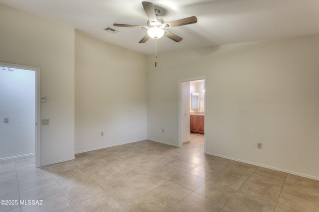 tiled empty room with ceiling fan