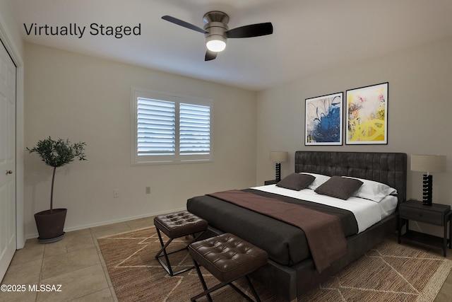 bedroom featuring a closet, ceiling fan, and light tile patterned flooring