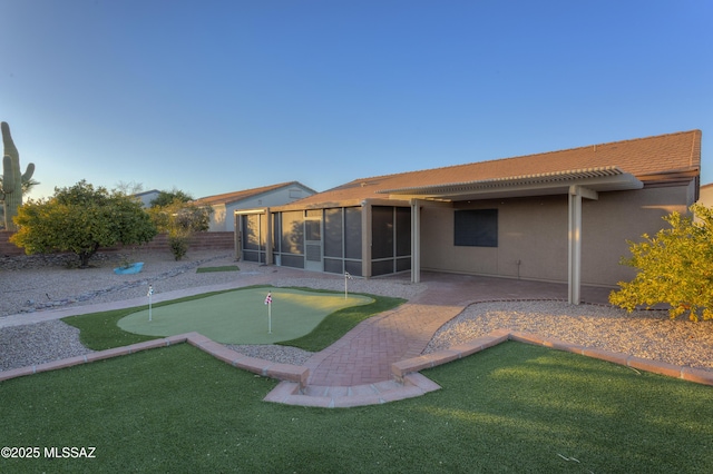 back of house with a patio and a sunroom