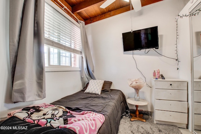 bedroom featuring vaulted ceiling with beams, ceiling fan, carpet, and wood ceiling