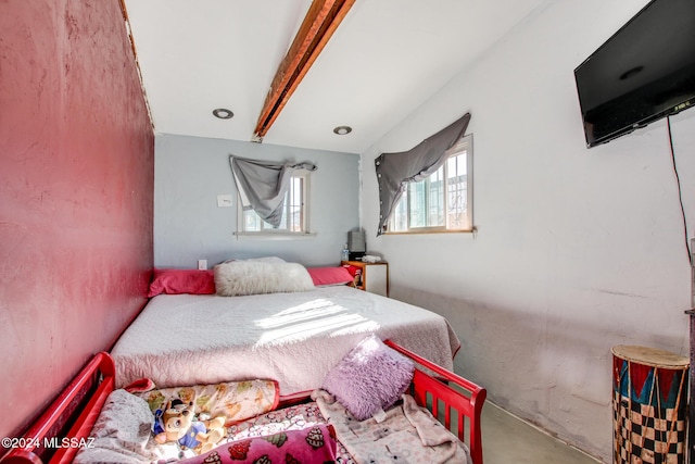 bedroom featuring beam ceiling and concrete floors