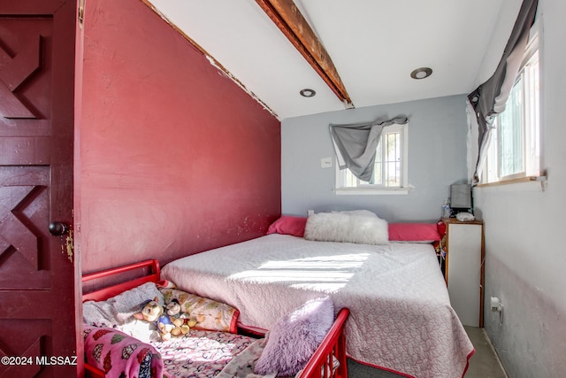 bedroom with lofted ceiling with beams