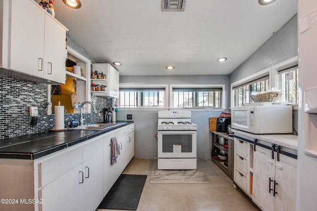 kitchen featuring white cabinets, white appliances, sink, and tasteful backsplash