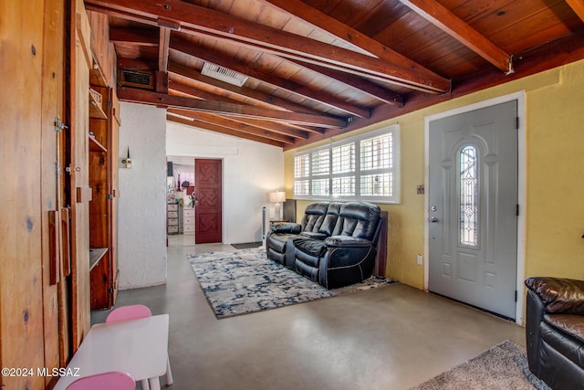 living room with lofted ceiling with beams, concrete flooring, and wood ceiling