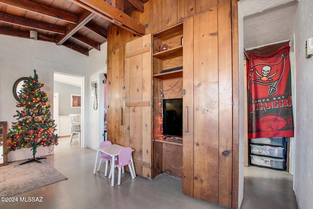 interior space featuring lofted ceiling with beams