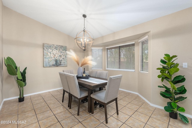 dining space featuring light tile patterned floors, vaulted ceiling, and a notable chandelier