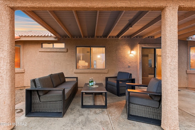 patio terrace at dusk featuring an outdoor hangout area