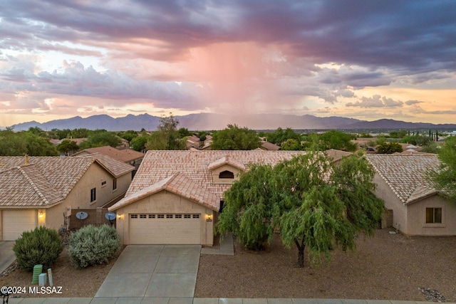 view of front facade with a mountain view and a garage