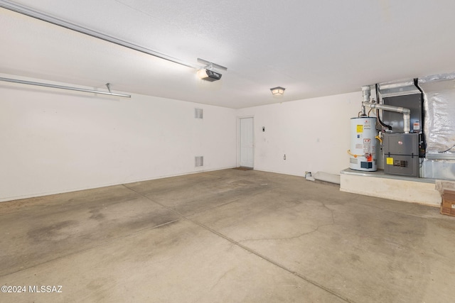 garage featuring heating unit, a garage door opener, and water heater