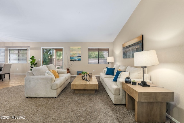 carpeted living room featuring vaulted ceiling