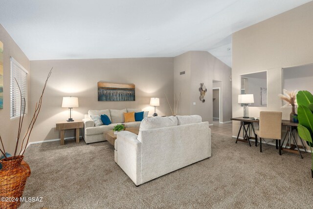 carpeted living room featuring high vaulted ceiling