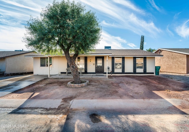 ranch-style home with covered porch and stucco siding