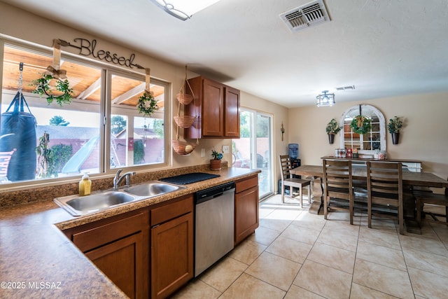 kitchen with dishwasher, light tile patterned floors, and sink